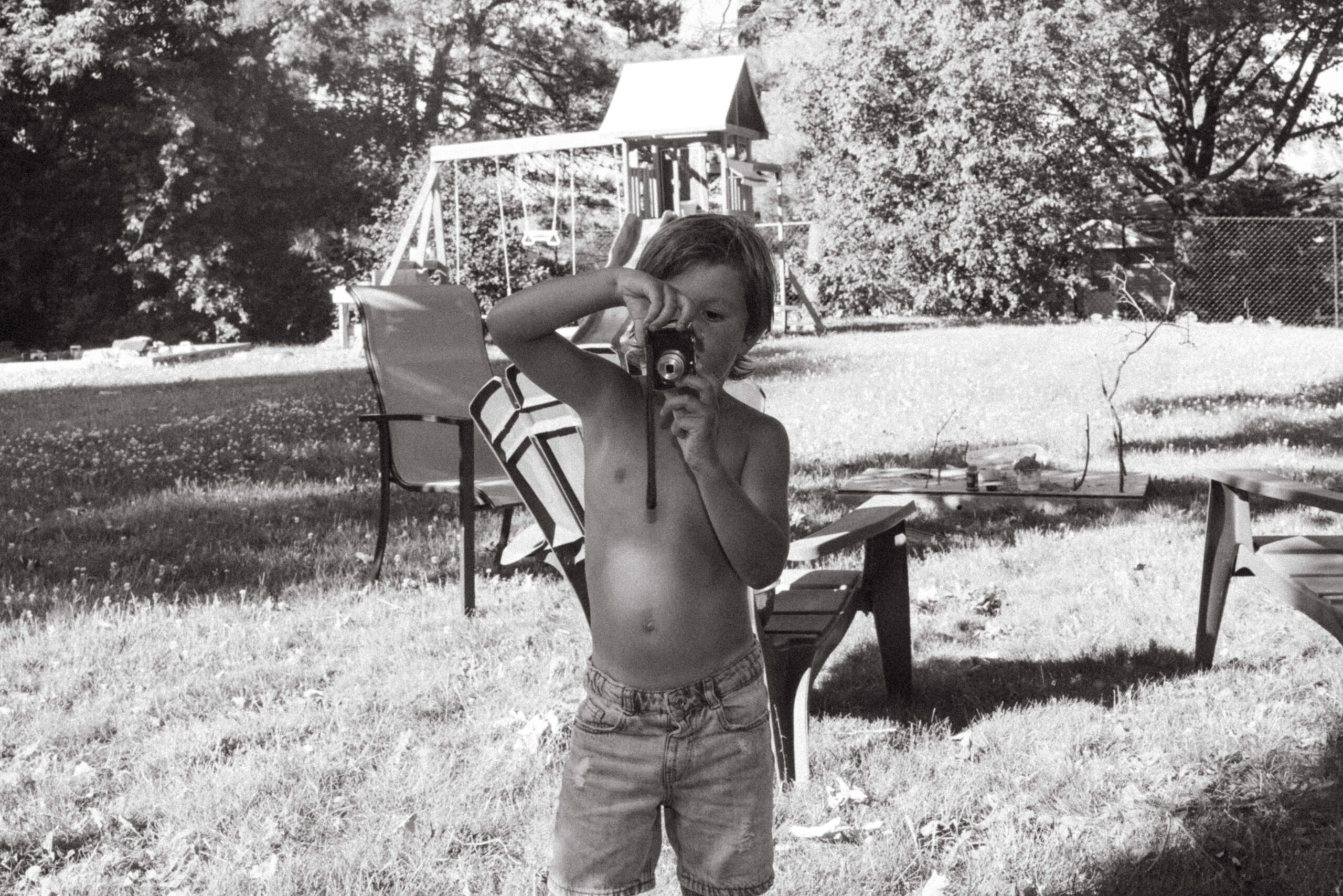 cute candid moment of son with his camera 