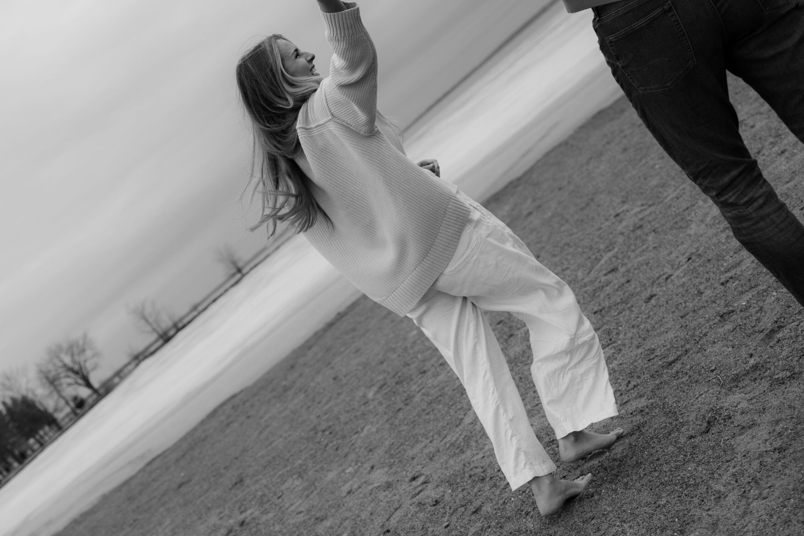couple session candid moment laughing on a beach