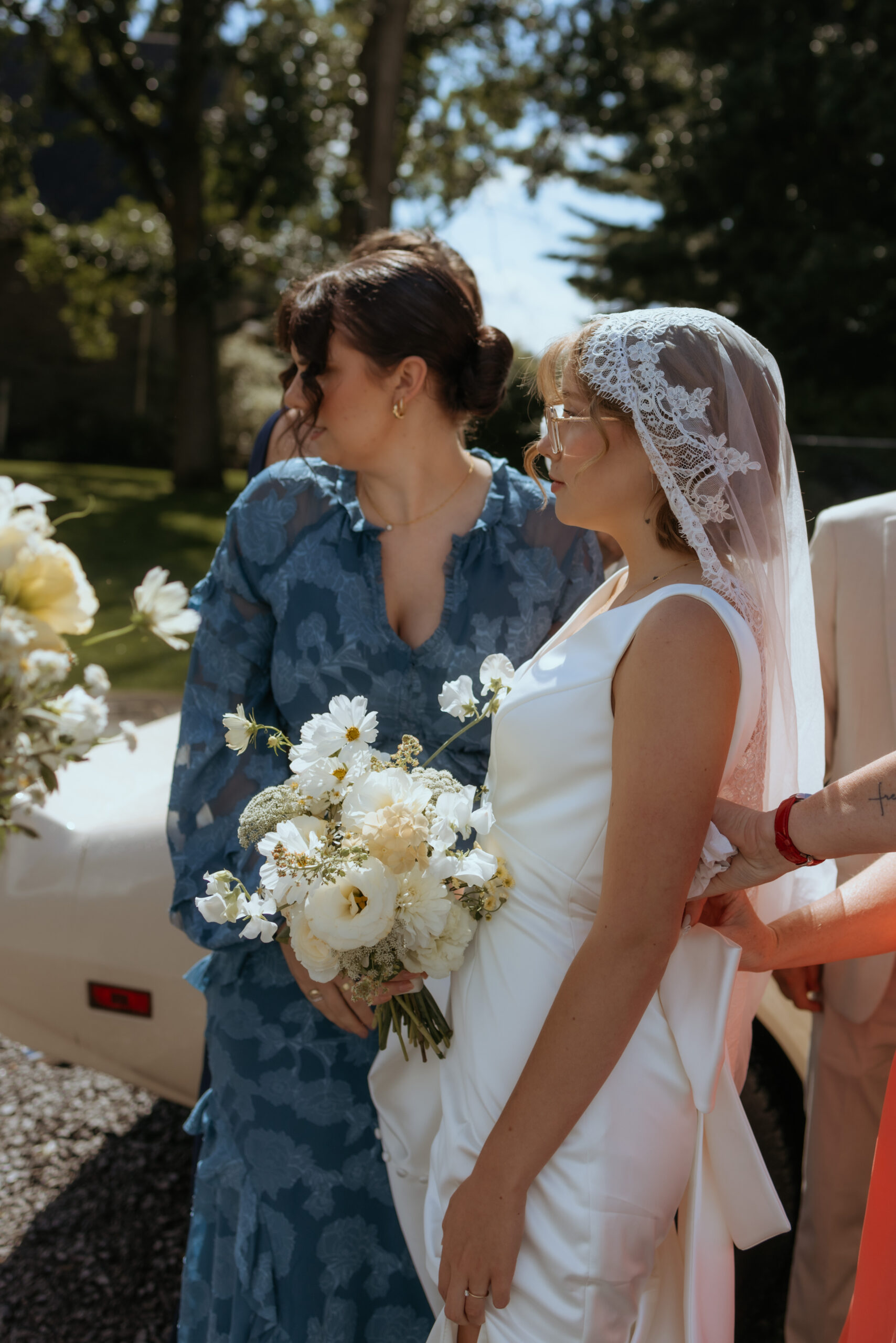 candid moment with bride and bridesmaid before walking down the ceremony 