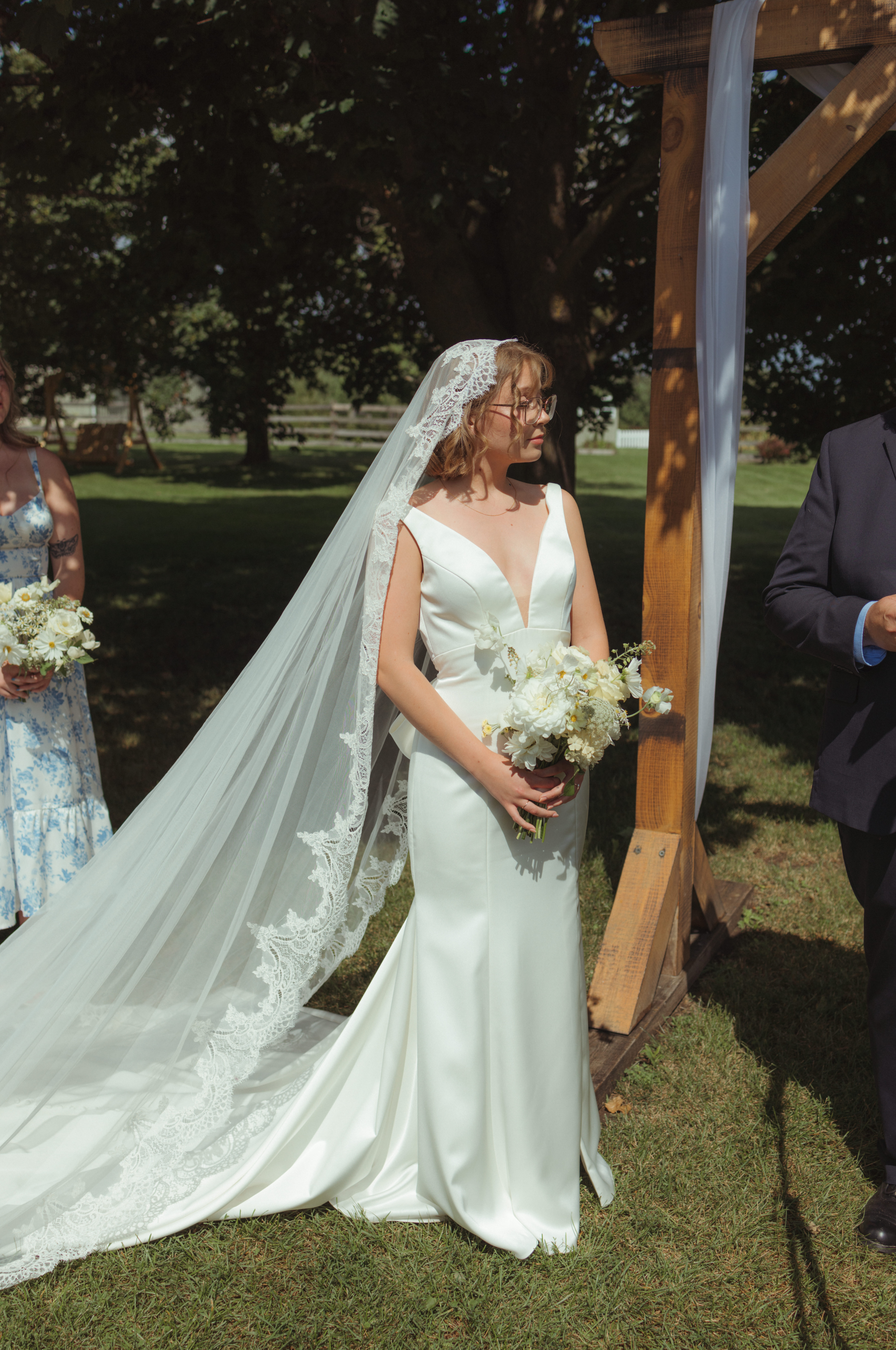 bride in sleek gown during an outdoor wedding ceremony