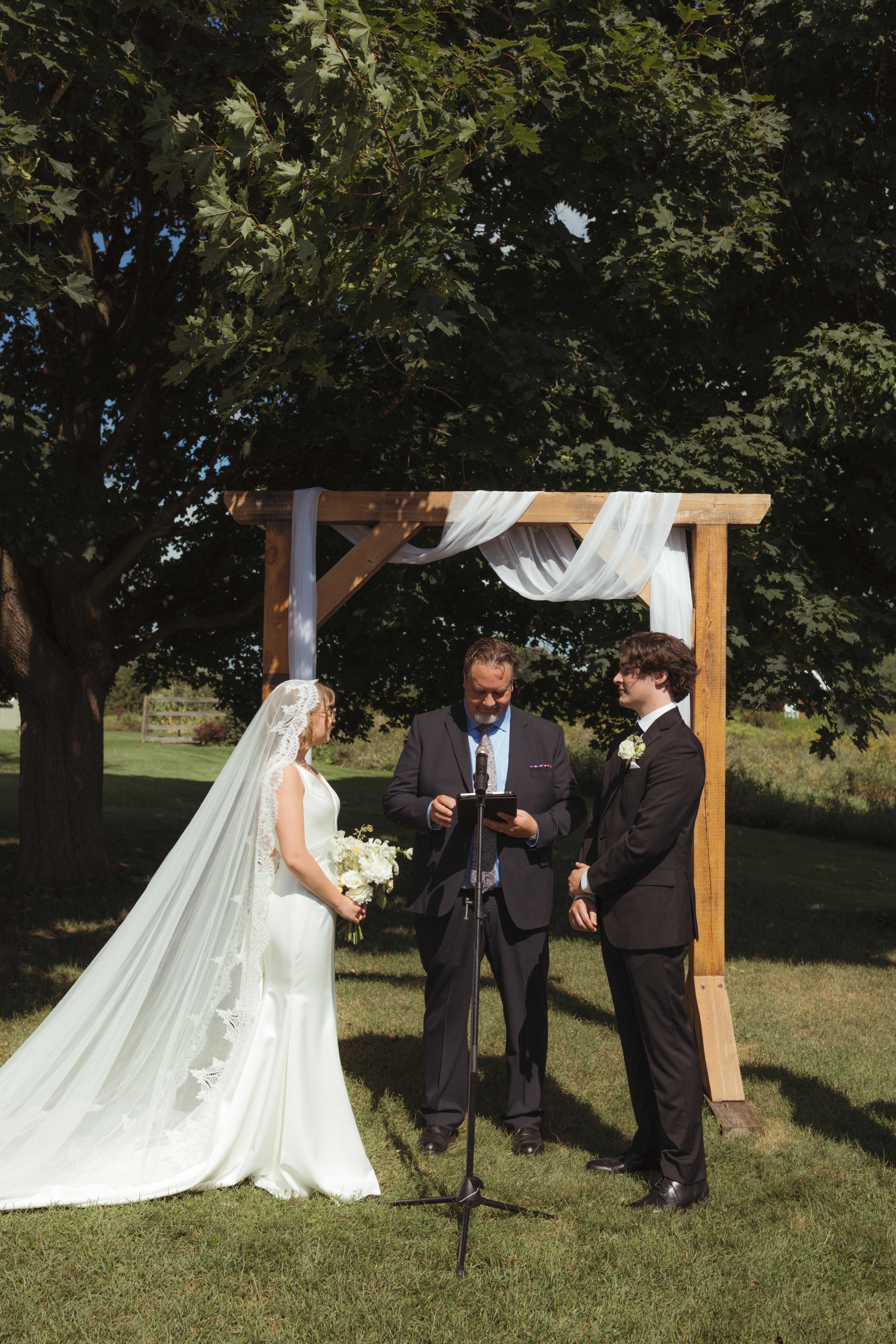 bride and groom candid moment during their summer ceremony 