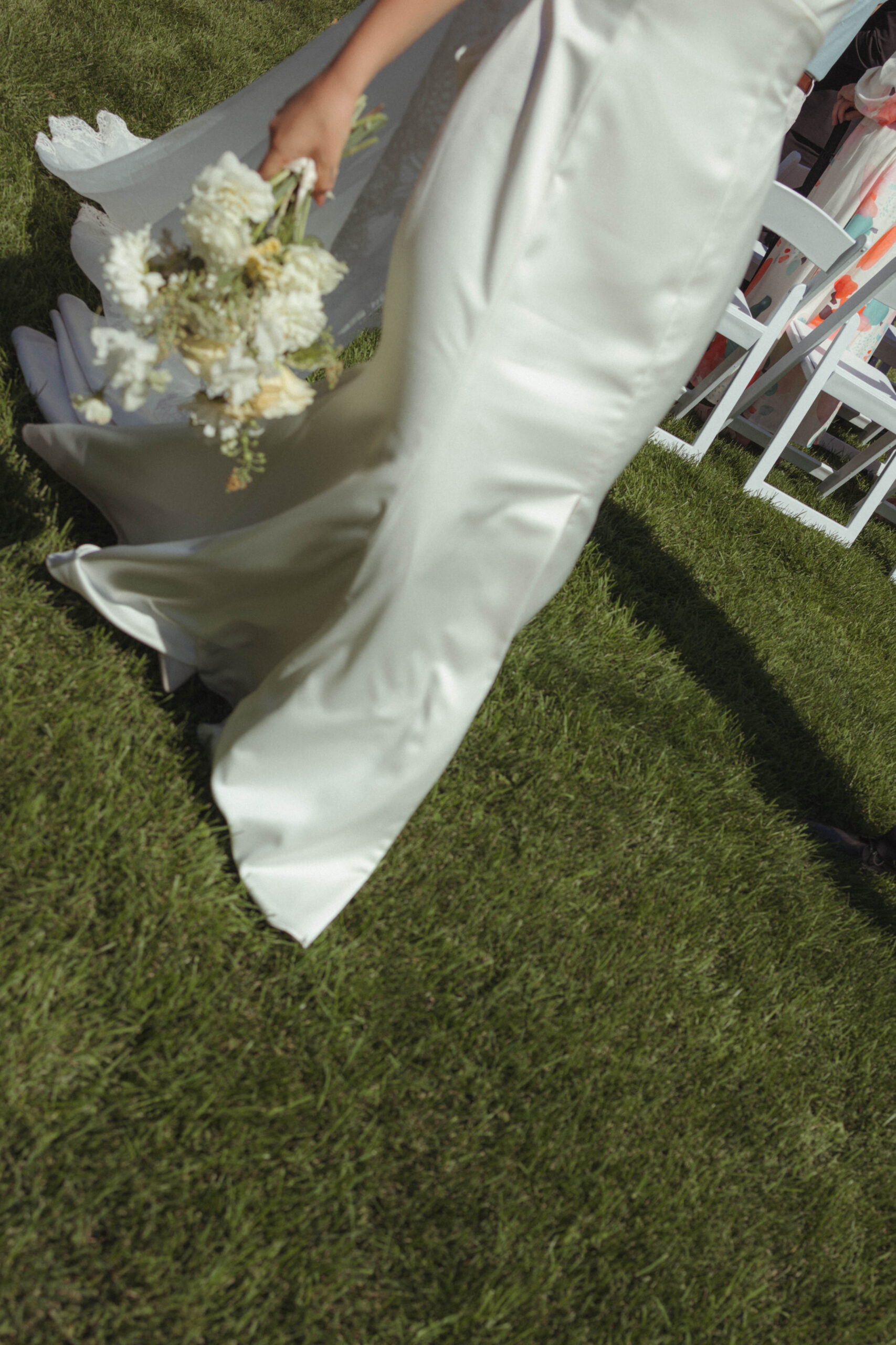 documentary moment of bride walking down aisle with her florals 