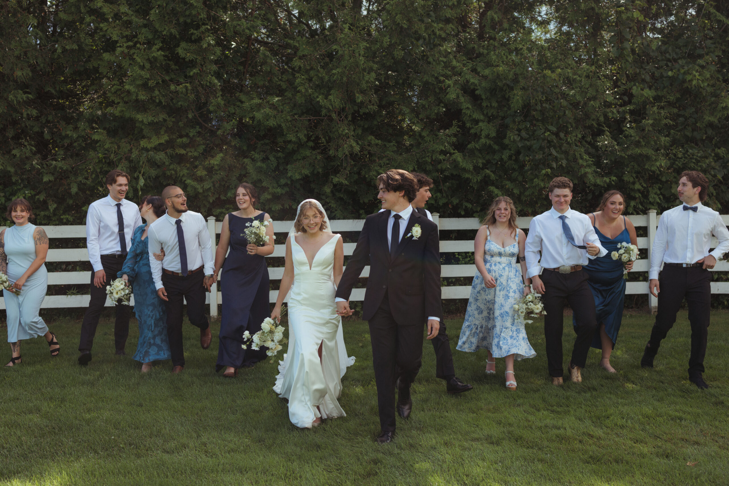 stylish wedding party walking with a mix matched of beautiful blue dresses 