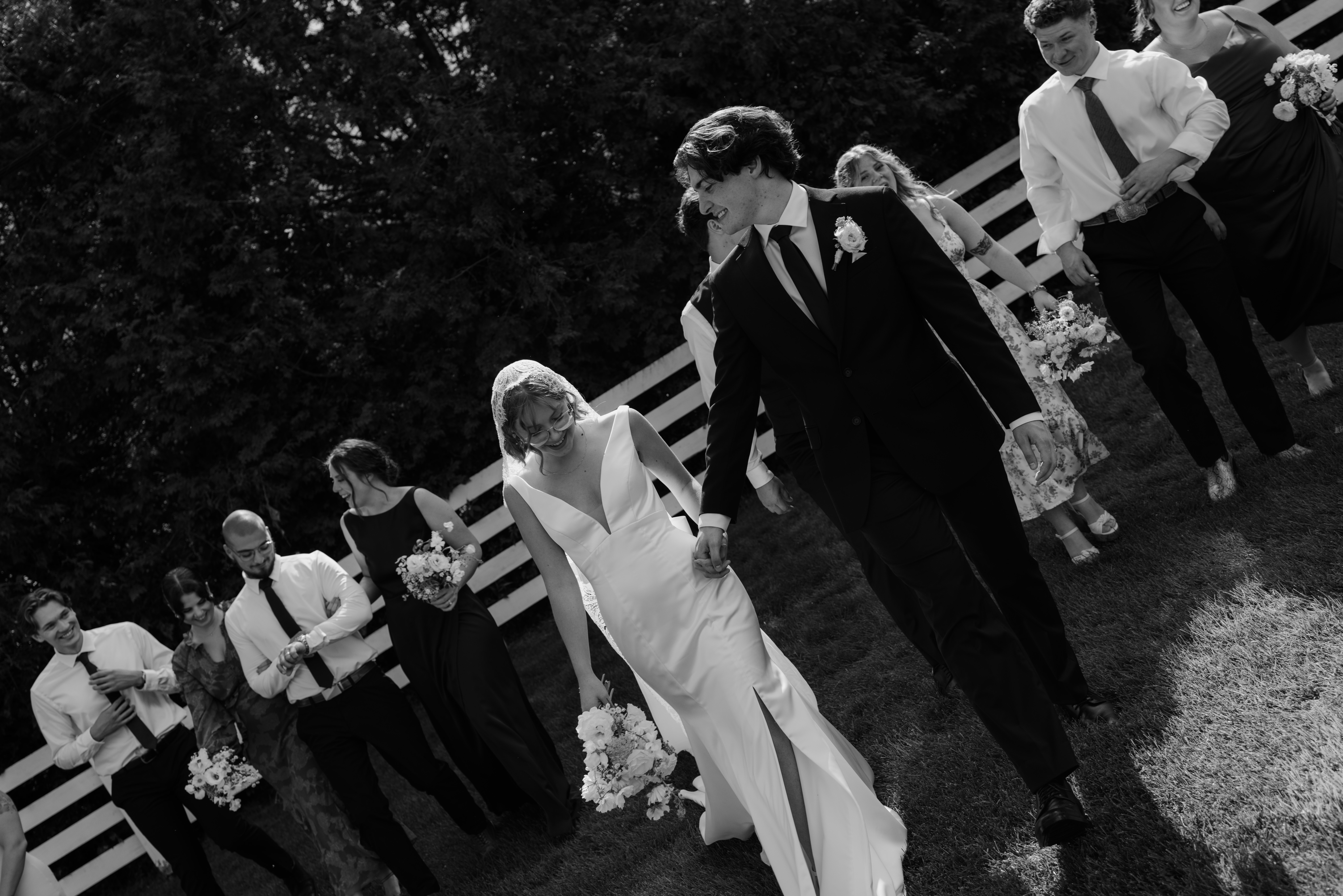 bride and groom walking with their bridal party after ceremony