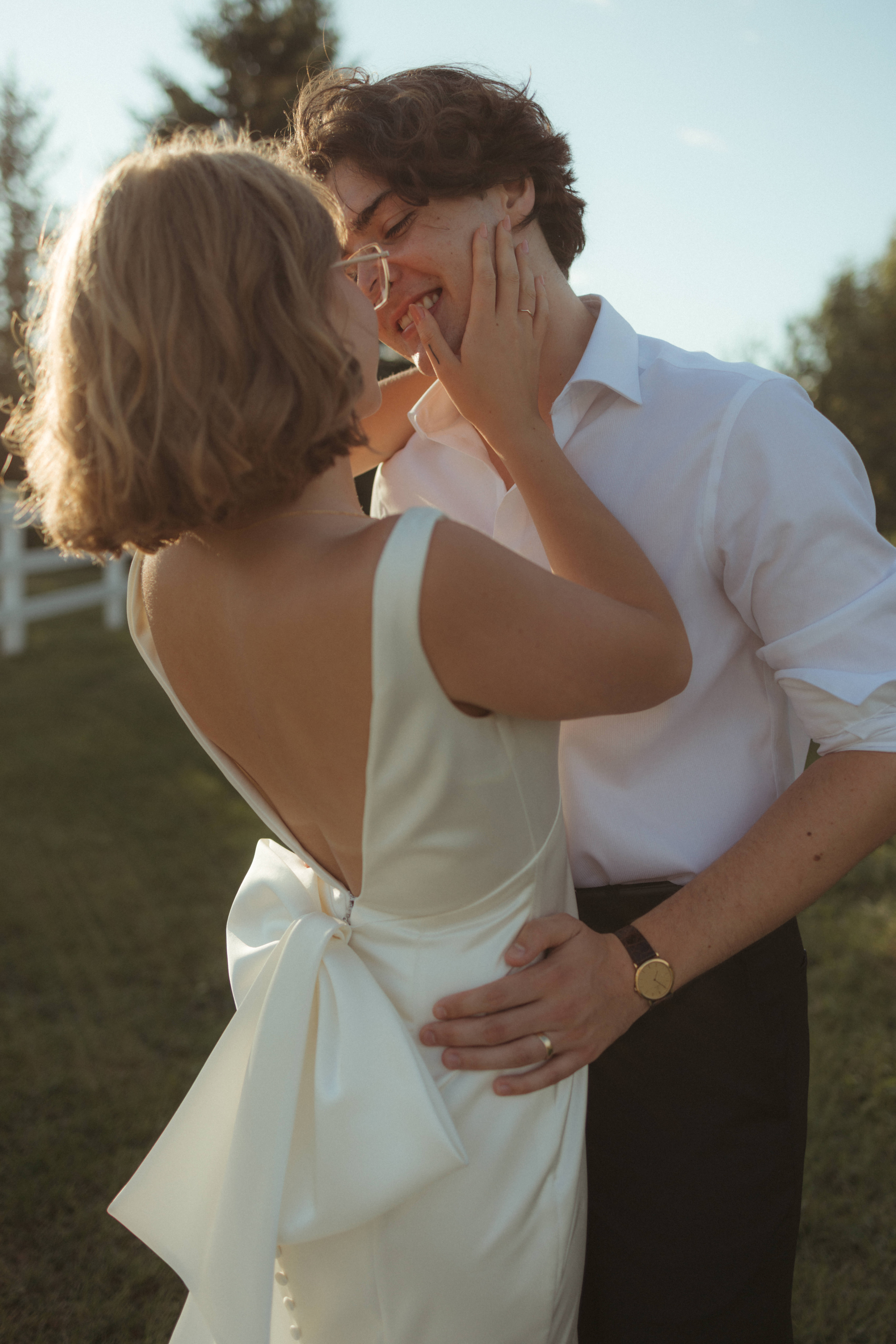 couple shares a kiss during golden hour while sneaking away from reception