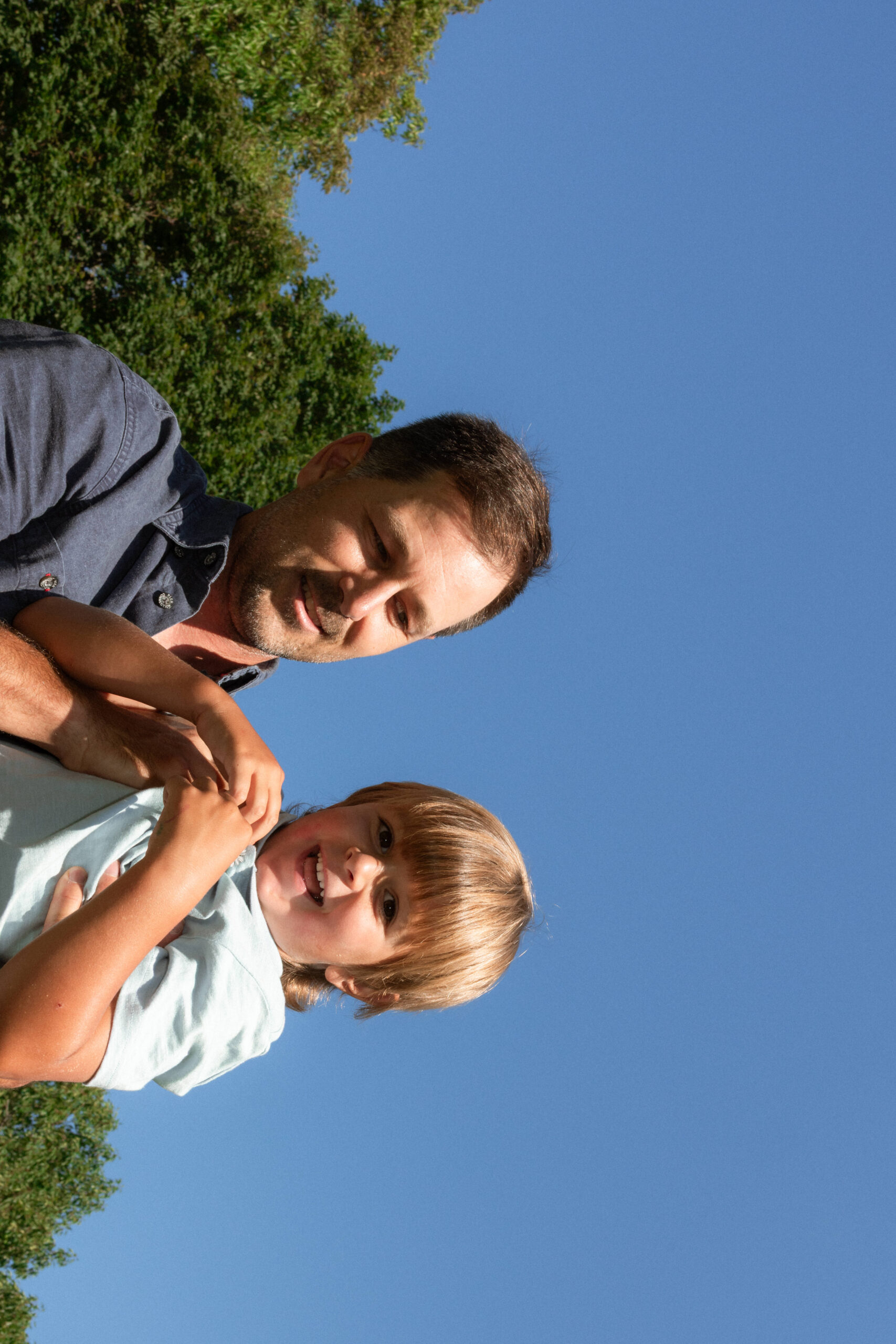 father holding son during family session