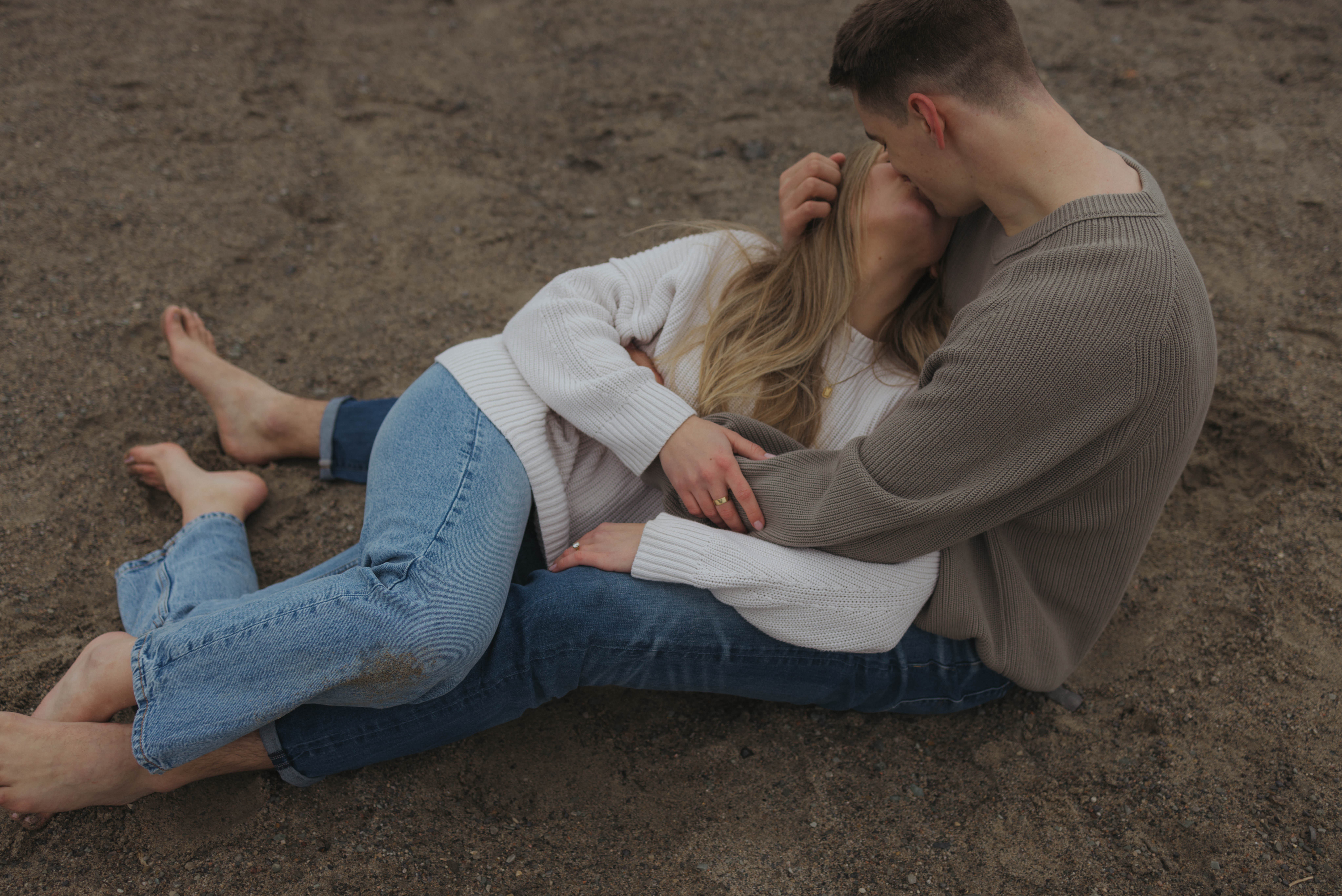 kissing on the beach during their documentary style engagement session