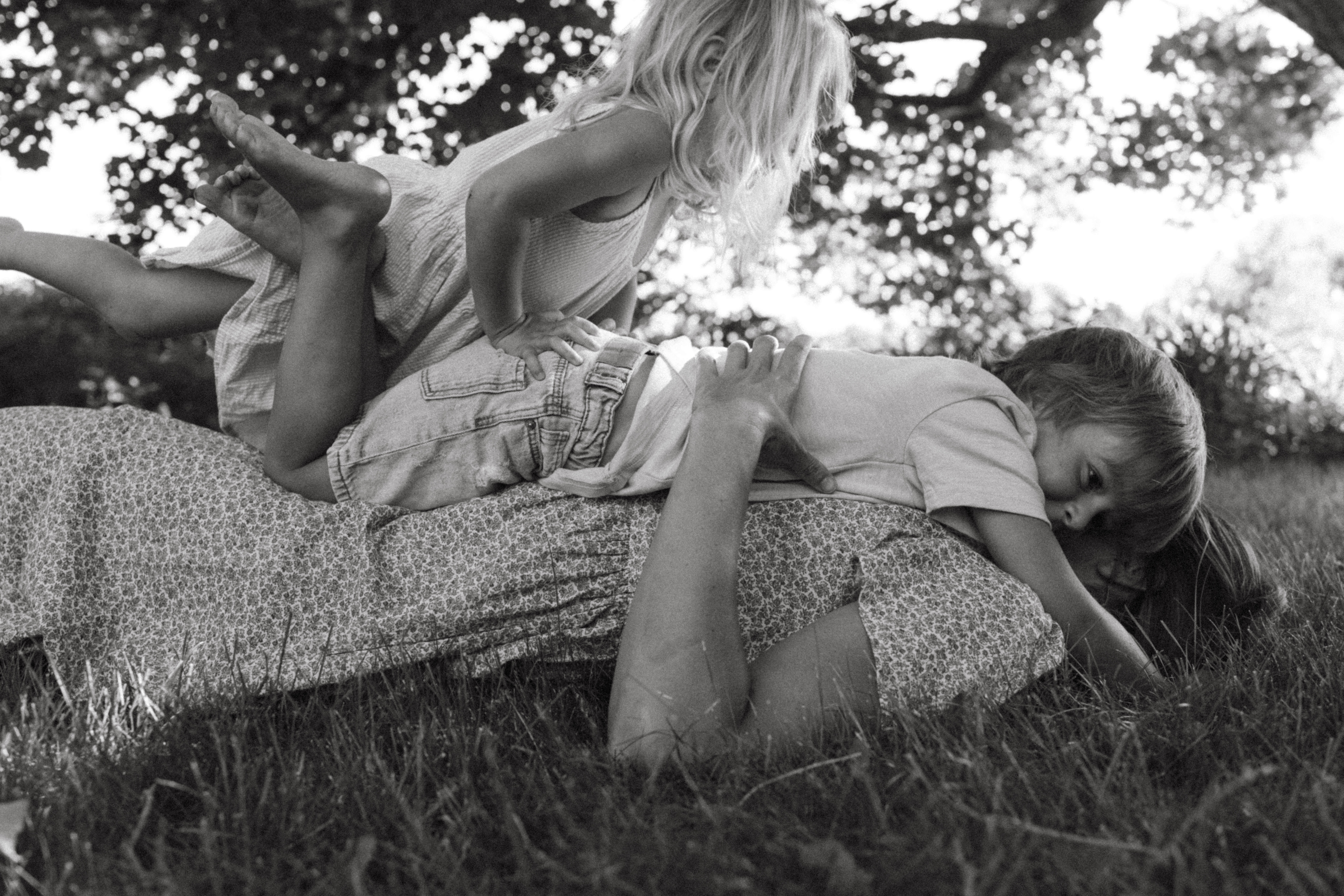 mother and child laying in the backyard during a documentary family session