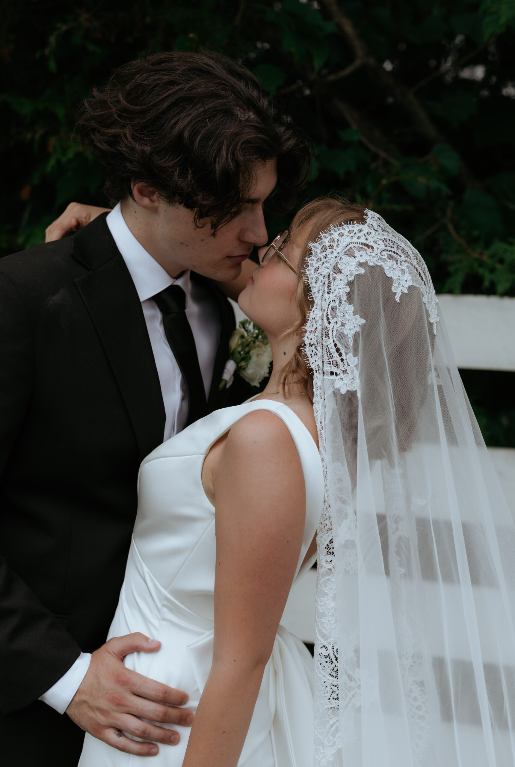 couple kiss after beautiful outdoor ceremony 