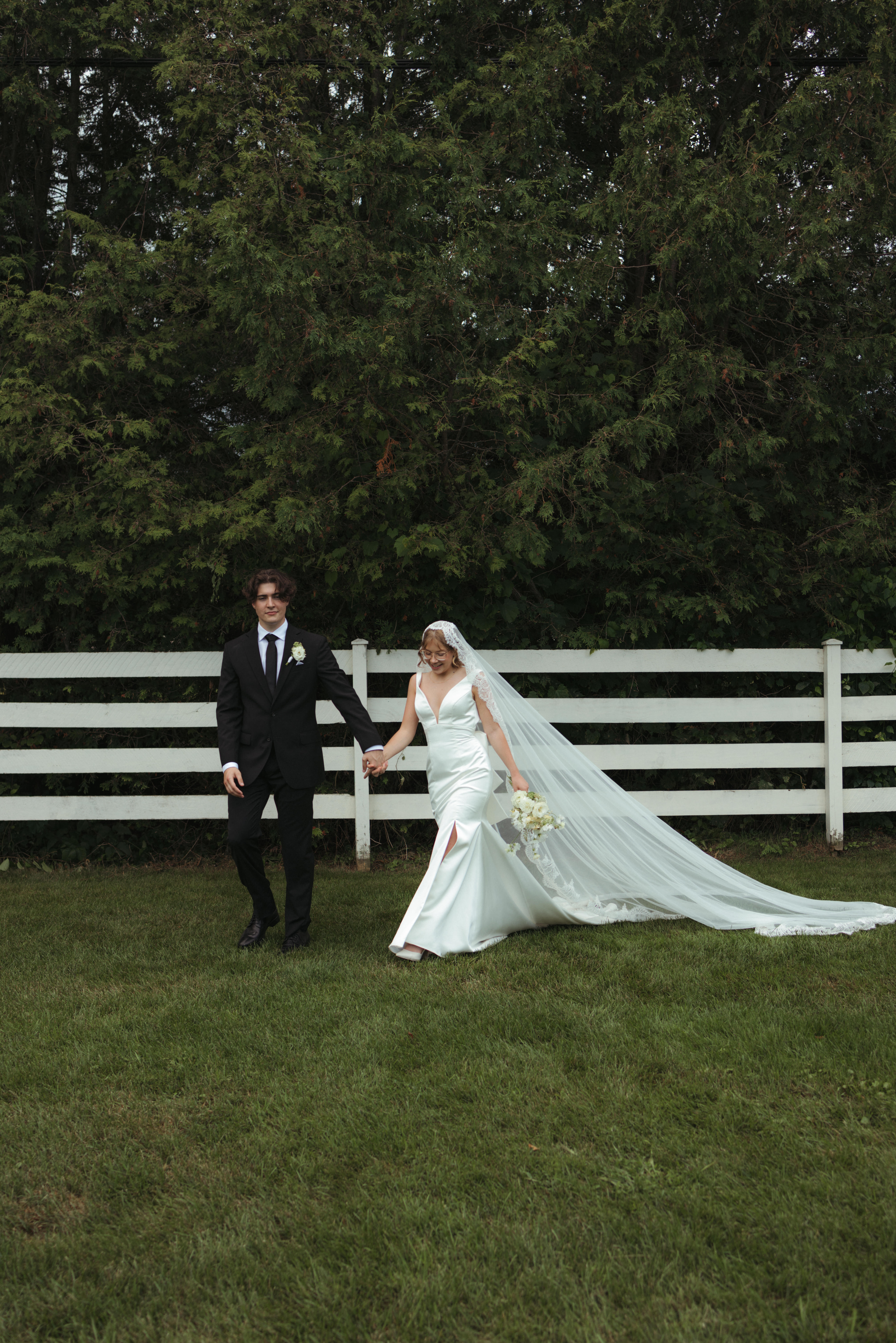 bride and groom walking toward wedding venue 