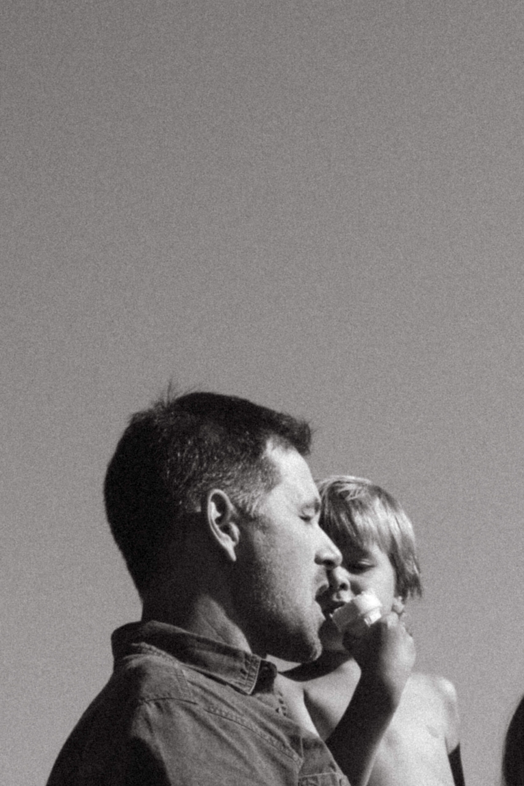 documentary family photographer in ottawa captures candid moment between father and son 