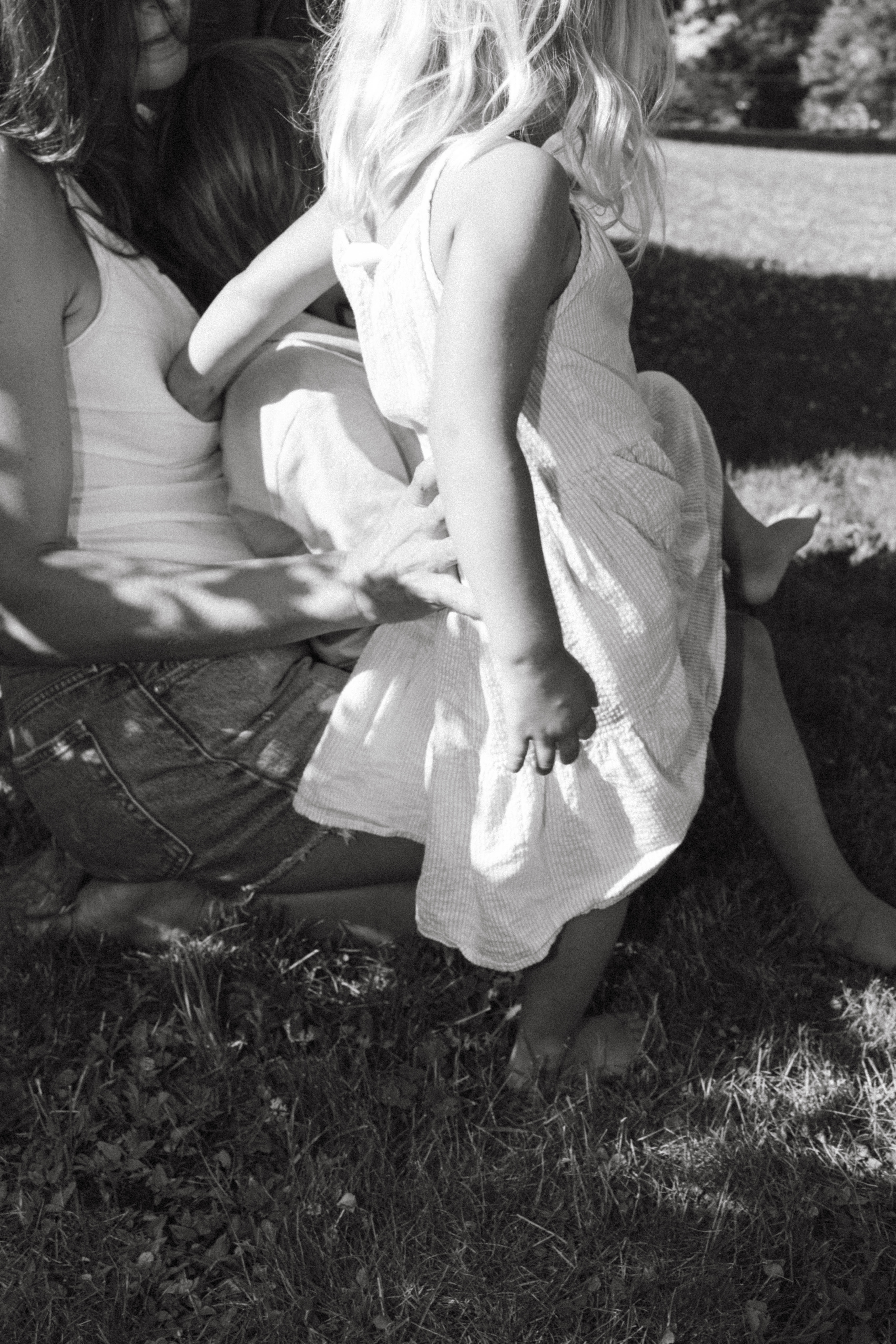 daughter sitting on moms lap during summer family session 